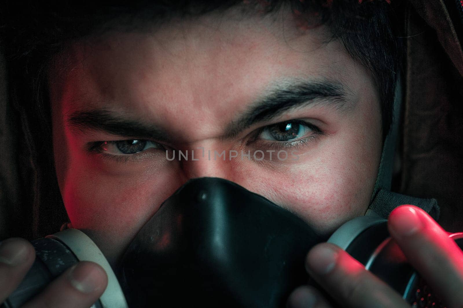 A man in a gas mask on a black background