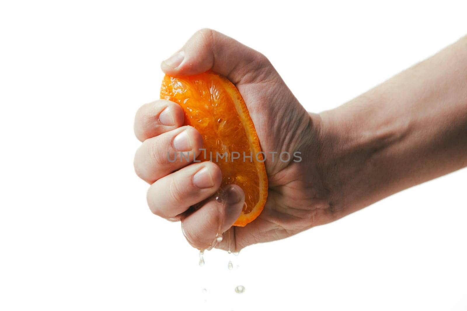 man dramatic squeezes orange. Concept squeezed a man is tired from work.