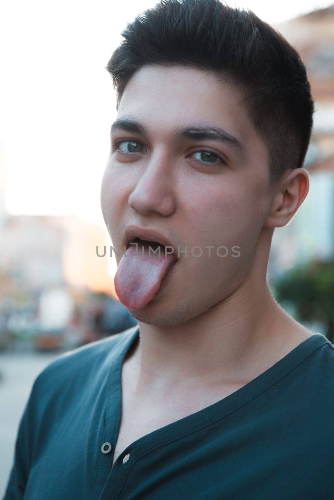 attractive young man showing his tongue