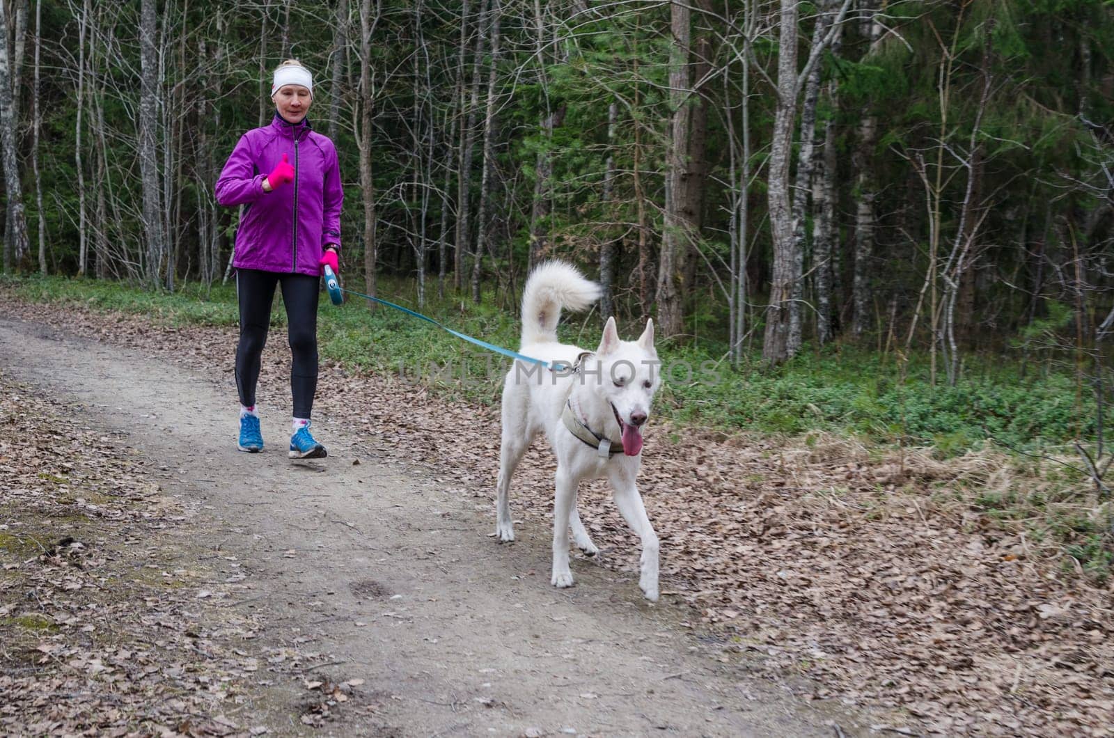 Woman with a dog on a run in the park