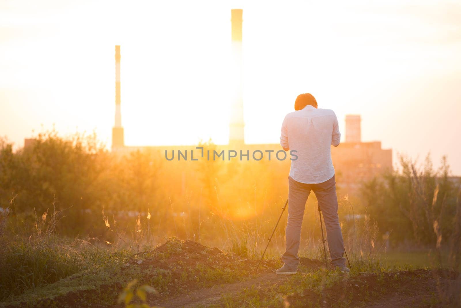 photographer shooting with sunset