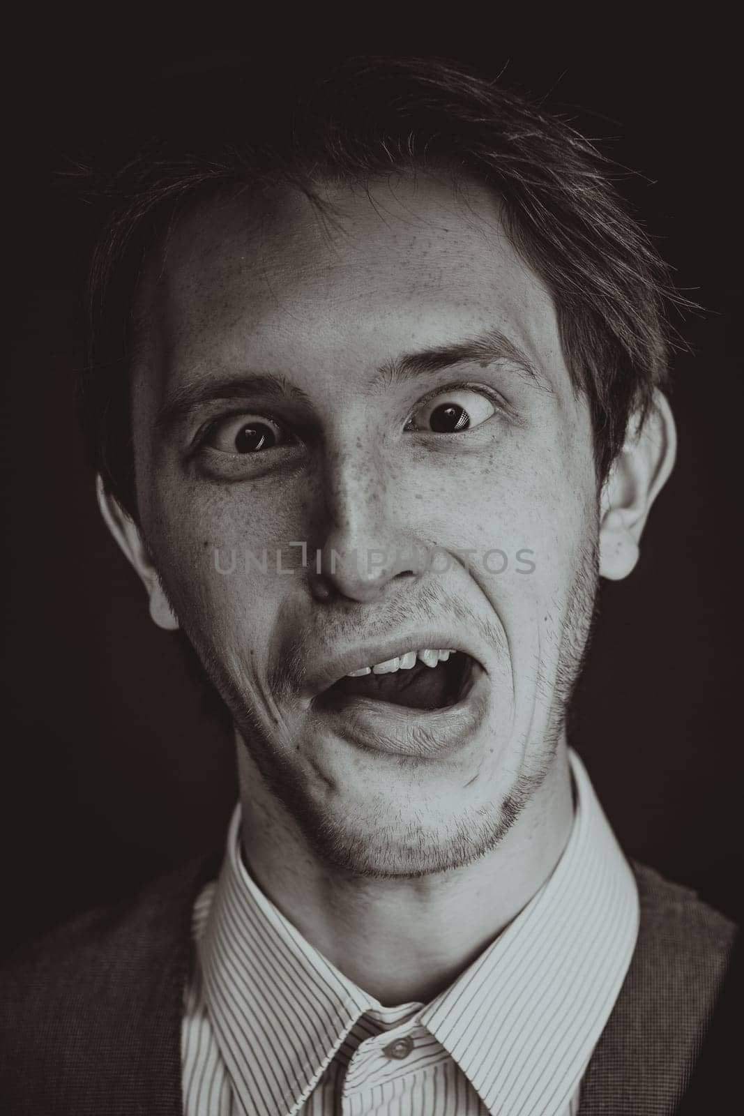 Studio shot of an handsome and expressive man on isolated backgroun