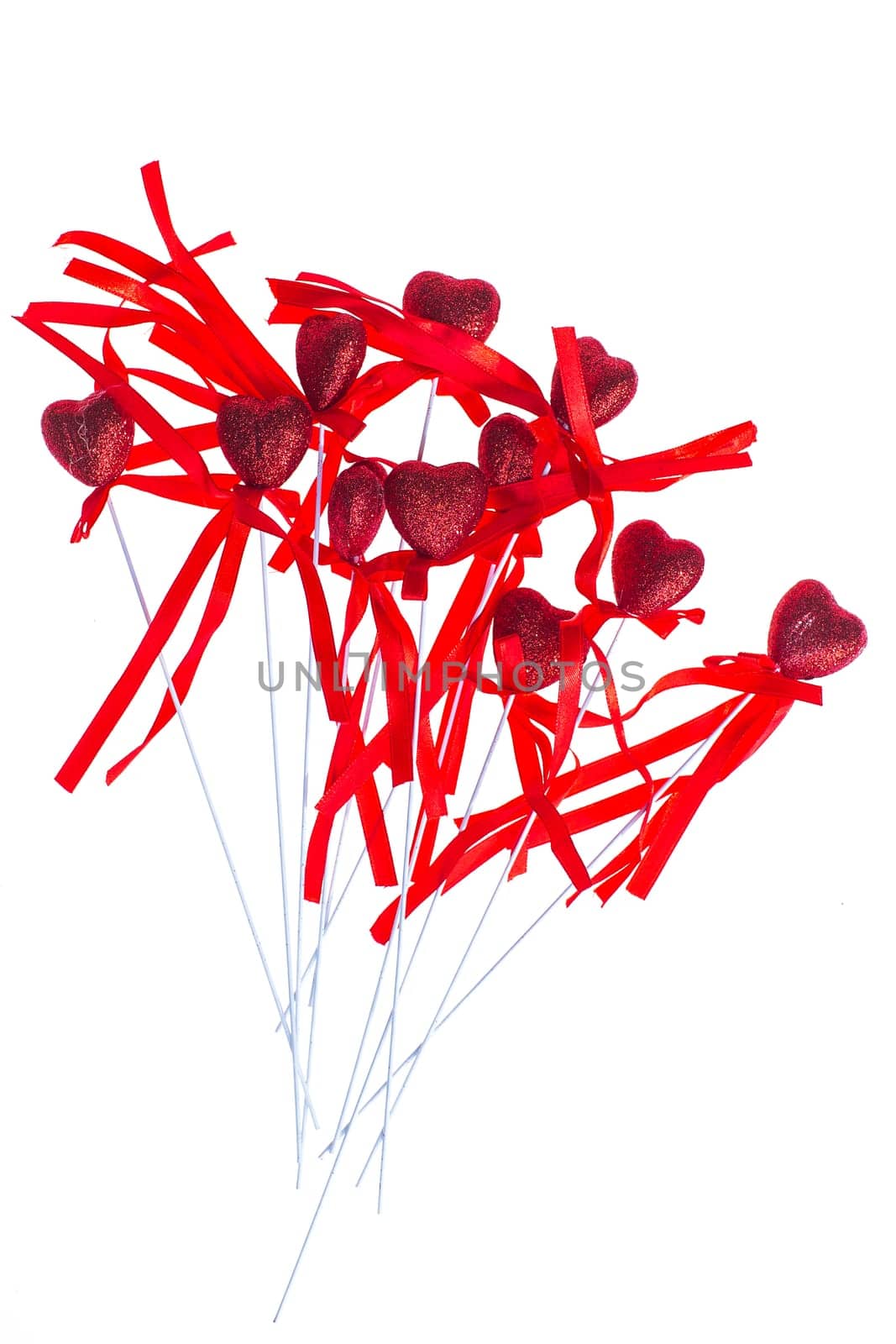 Red valentine heart shaped decorations with ribbon and bows isolated over white background.