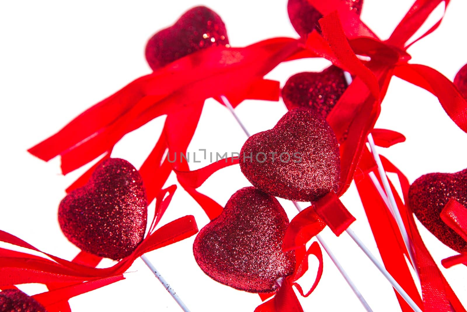 Red valentine heart shaped decorations with ribbon and bows isolated over white background.