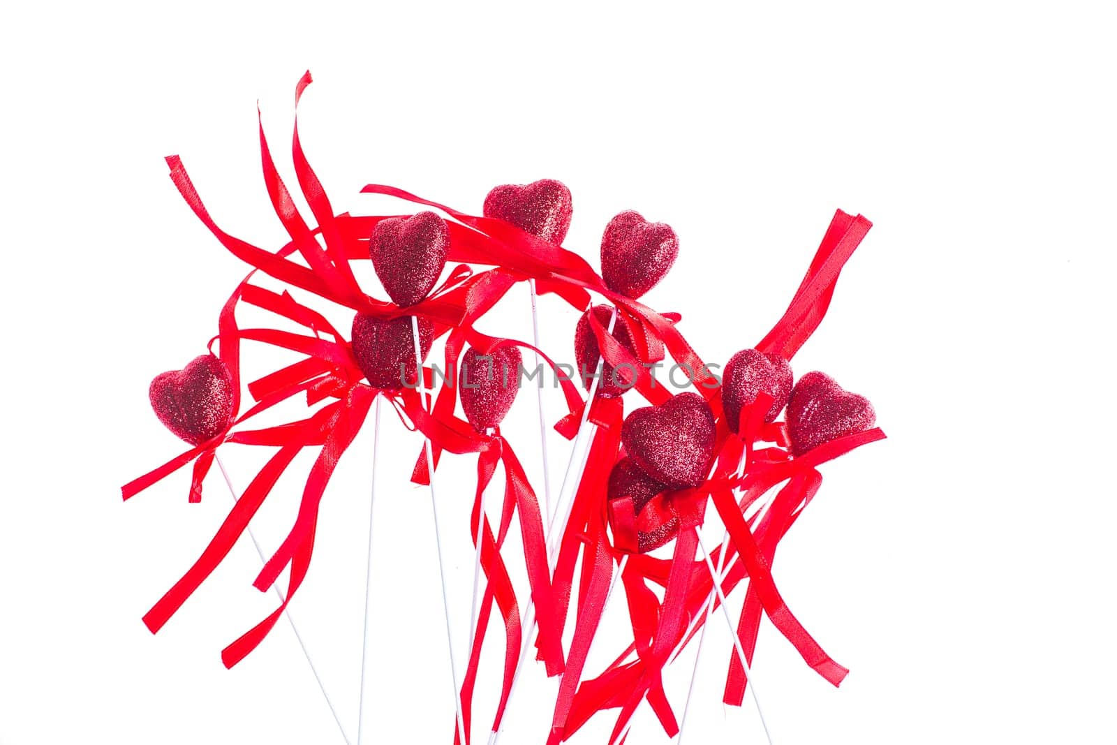 Red valentine heart shaped decorations with ribbon and bows isolated over white background.