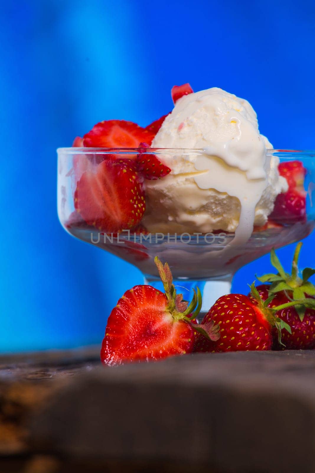 Strawberry ice cream with wooden and blue background