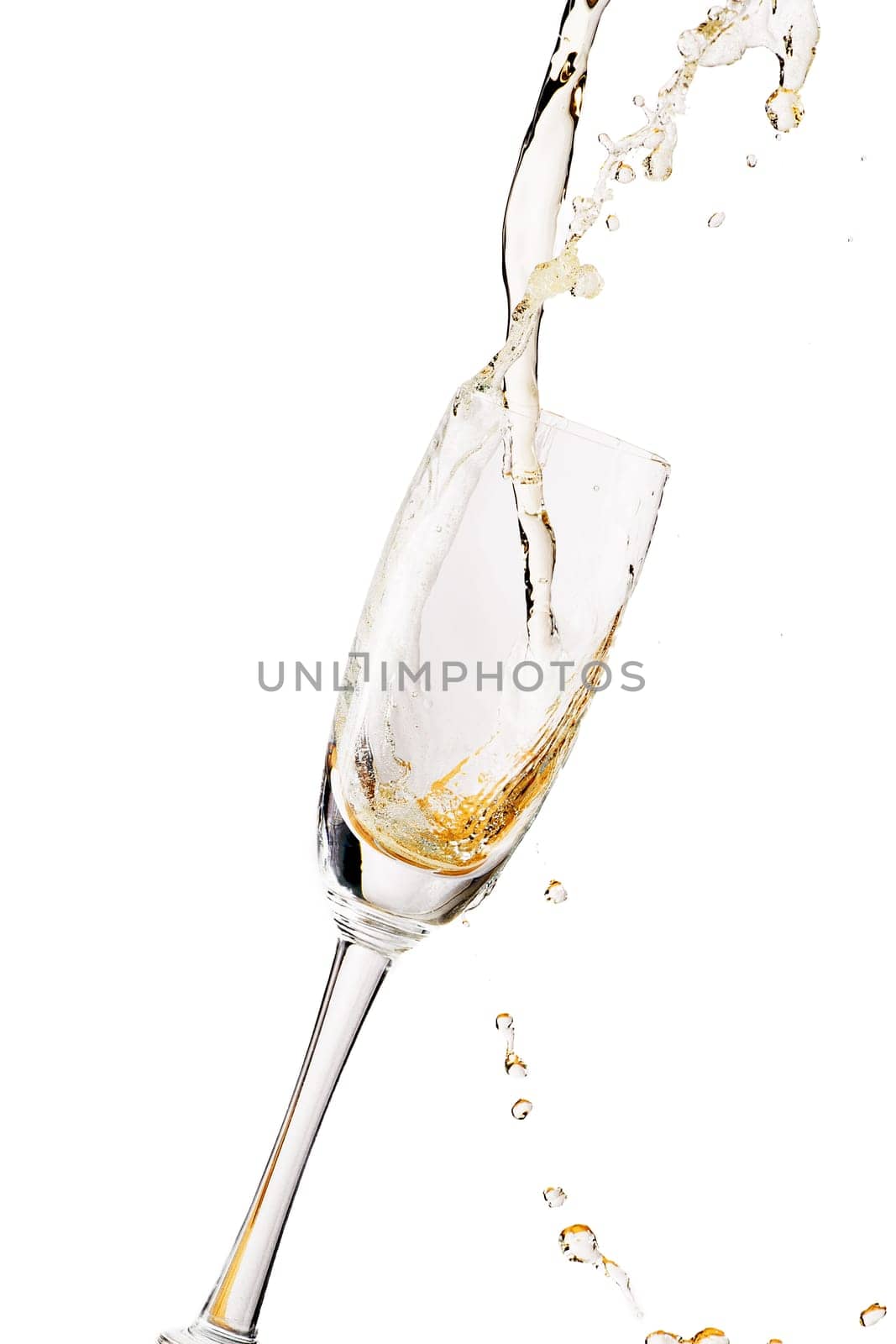 White wine splashing out of glass, isolated on white background