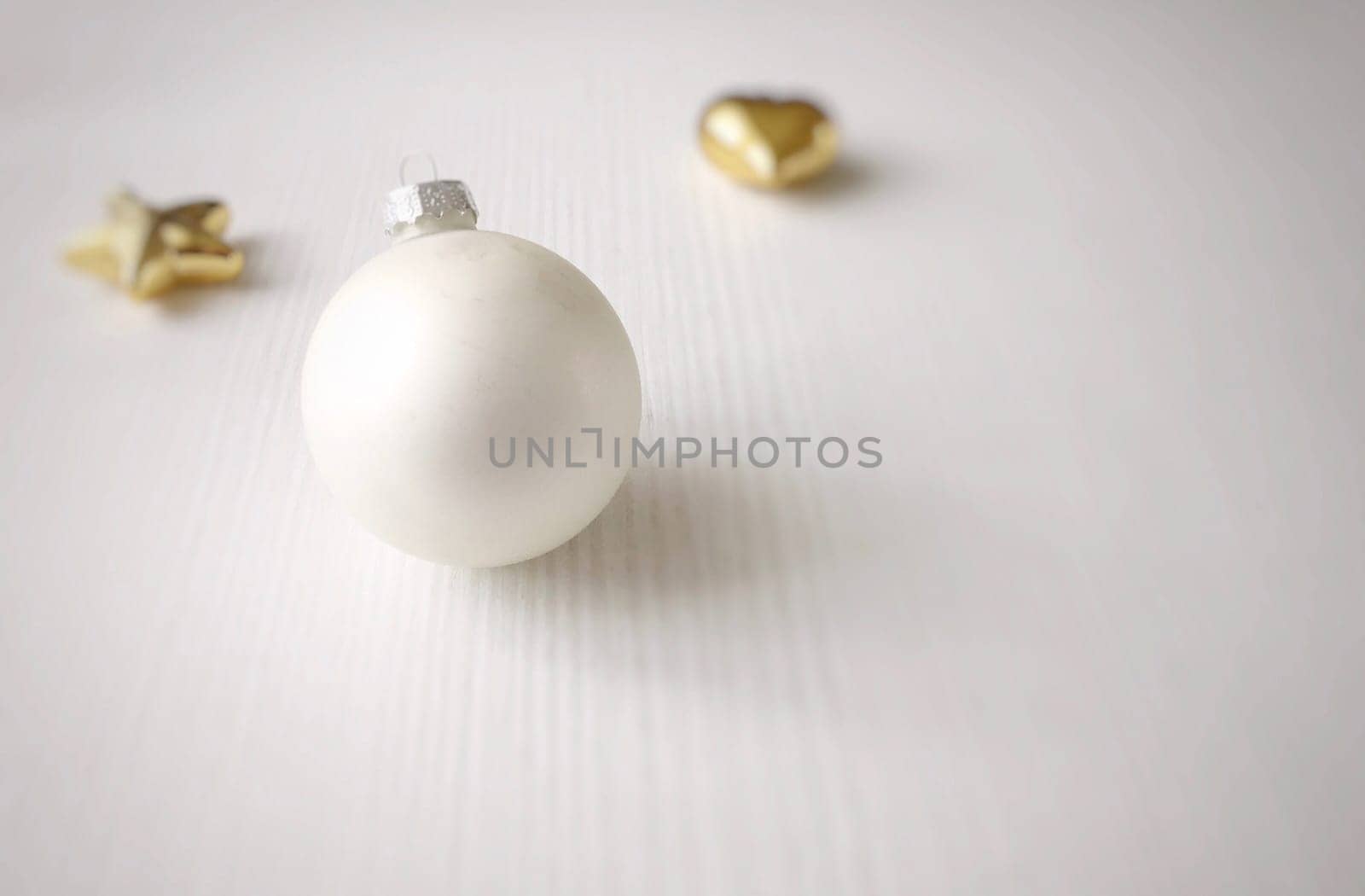 white christmas ball on a white wooden table