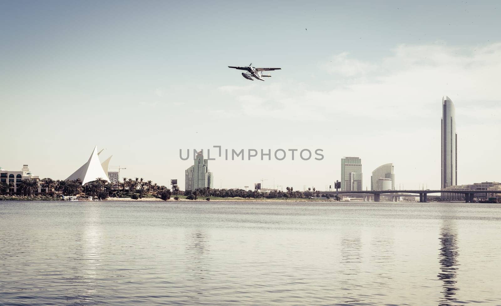 Seaplane taking off from Dubai Creek near Park Hyatt golf course