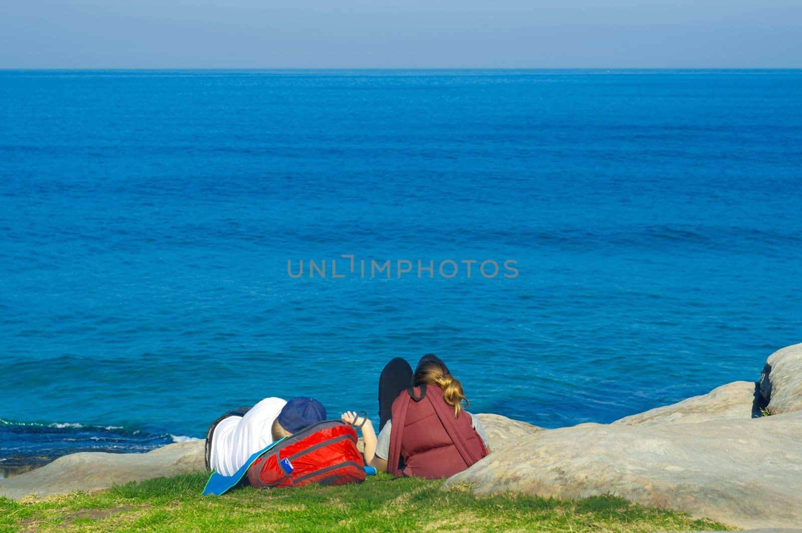 two lovers relaxing in the mountains near the sea