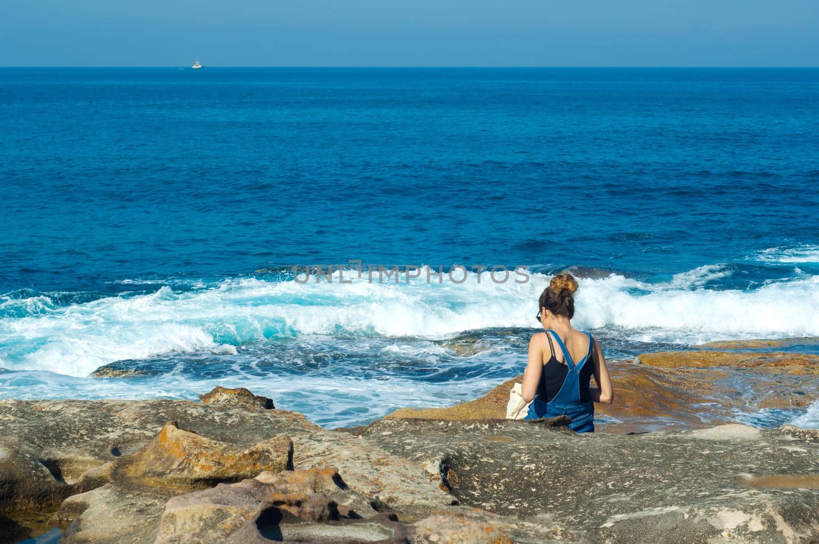 young woman against the blue sea