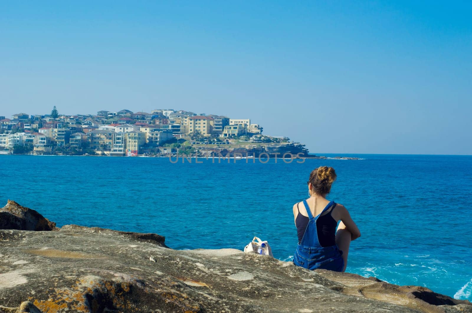 young woman against the blue sea