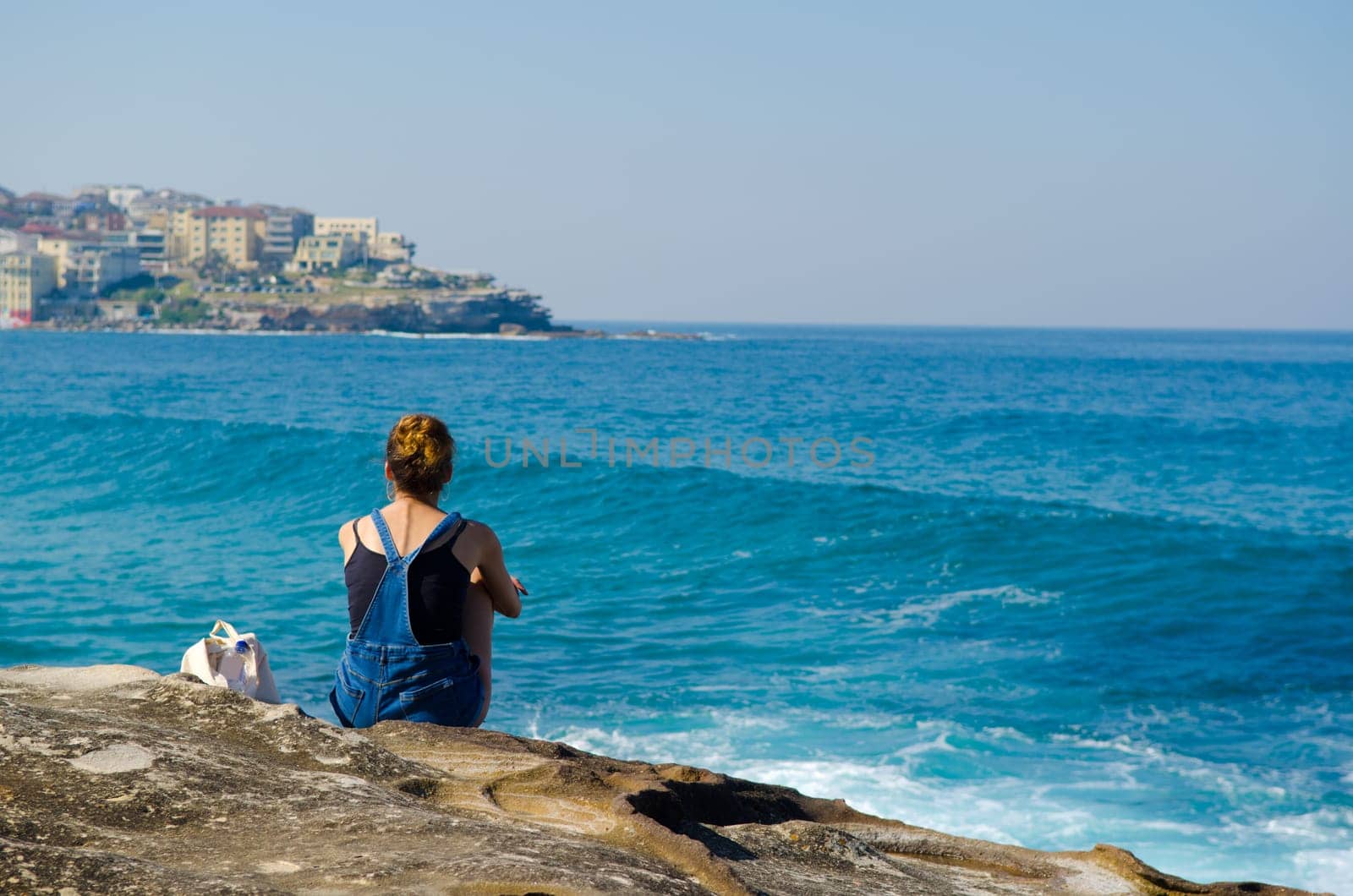 young woman against the blue sea