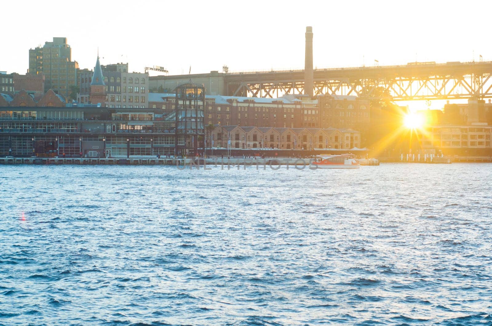generic modern city with water reflection in sunset, harbor city in Sydney.