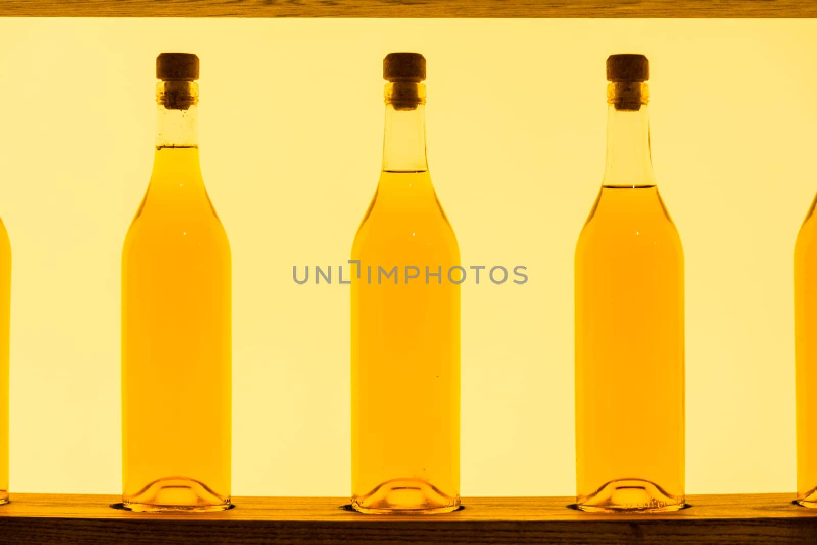 Abstract Yellow Clear Glass Bottles Shelf Backlit