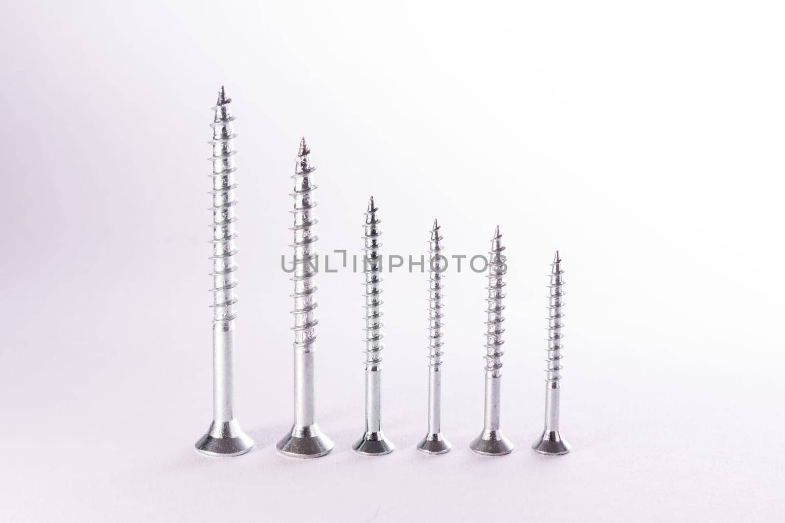 Decreasing Bar Graph Pattern Metal Screws Construction White Background