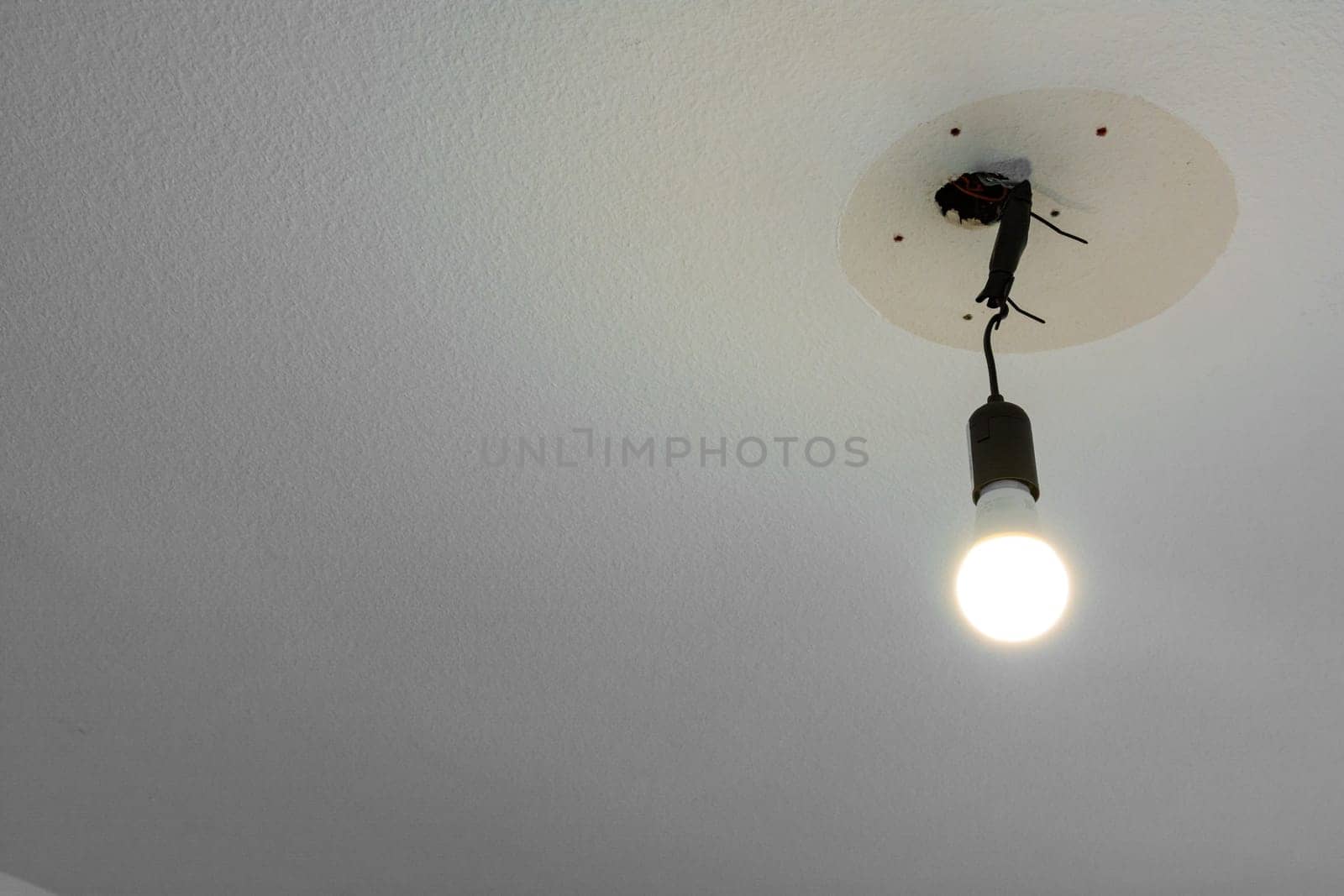Light Bulb Hanging From Ceiling Illuminated Wire White Blank