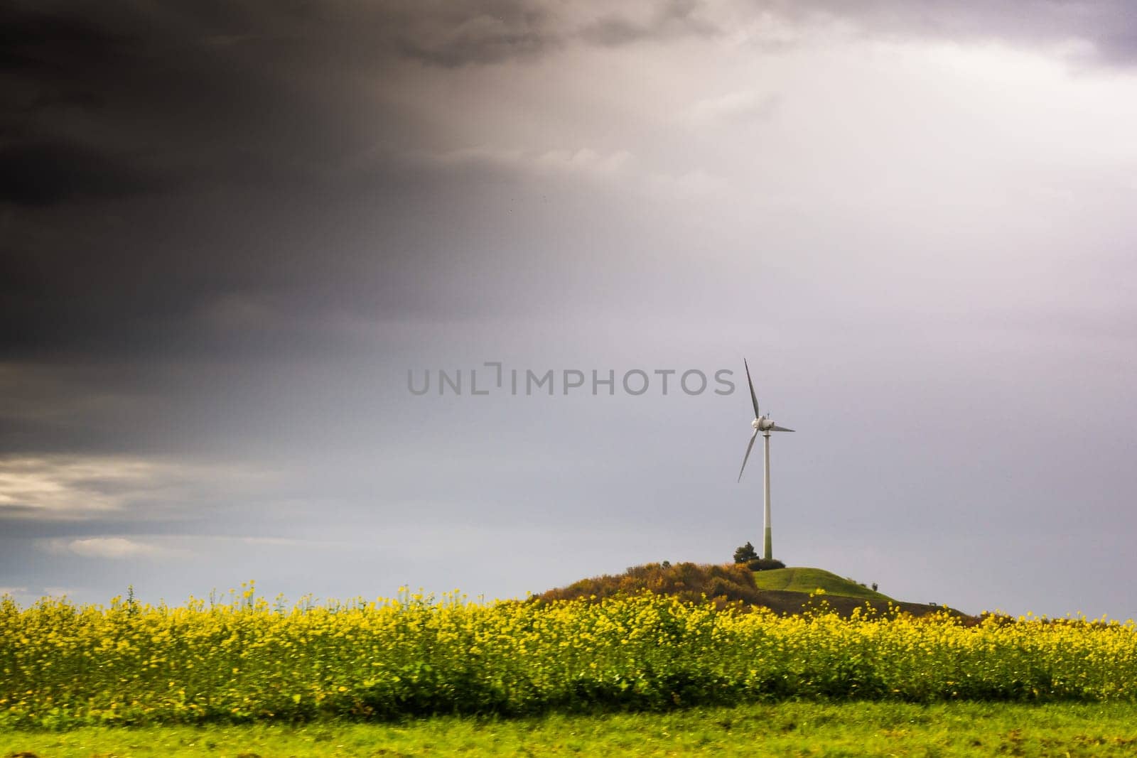 Single Windmill Turbine Hill Flowers Yellow Driving Highway Motion Blur Landscape Overcast Weather Sustainable Energy Germany Europe Green Clouds Heavy Vignette