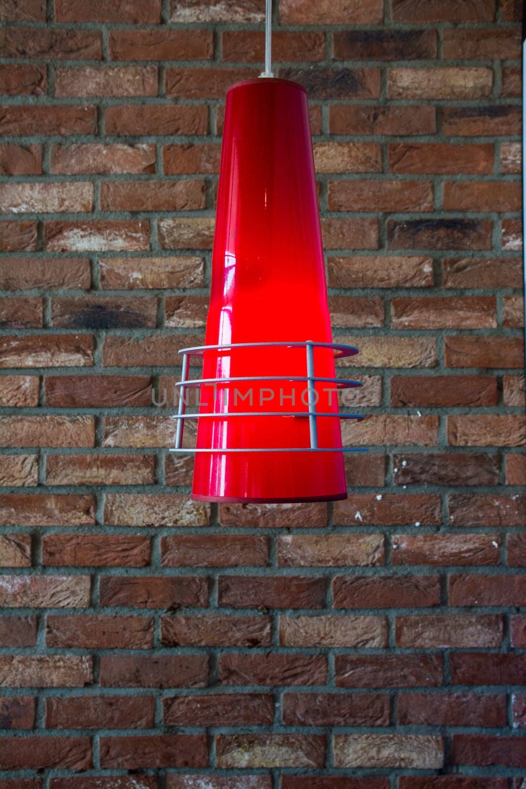 Stylish Cone Lamp Hanging with Blurred Brick Wall
