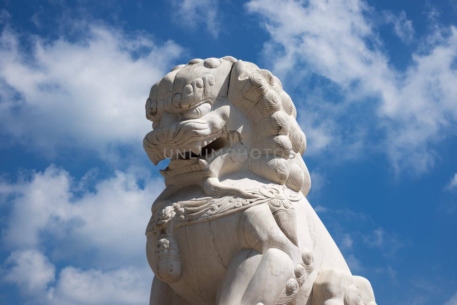 Chinese Lion marble, buddhist figurine with blue sky
