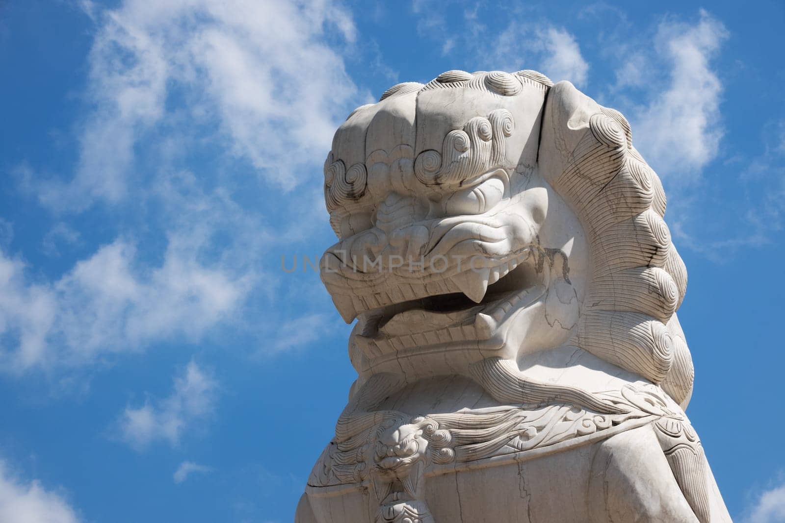 Chinese Lion marble, buddhist figurine with blue sky