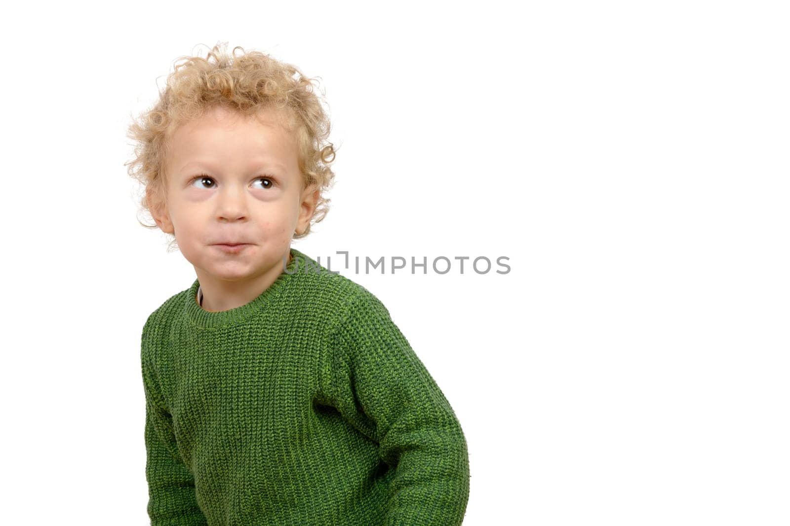 a little boy with a naughty look on the white background
