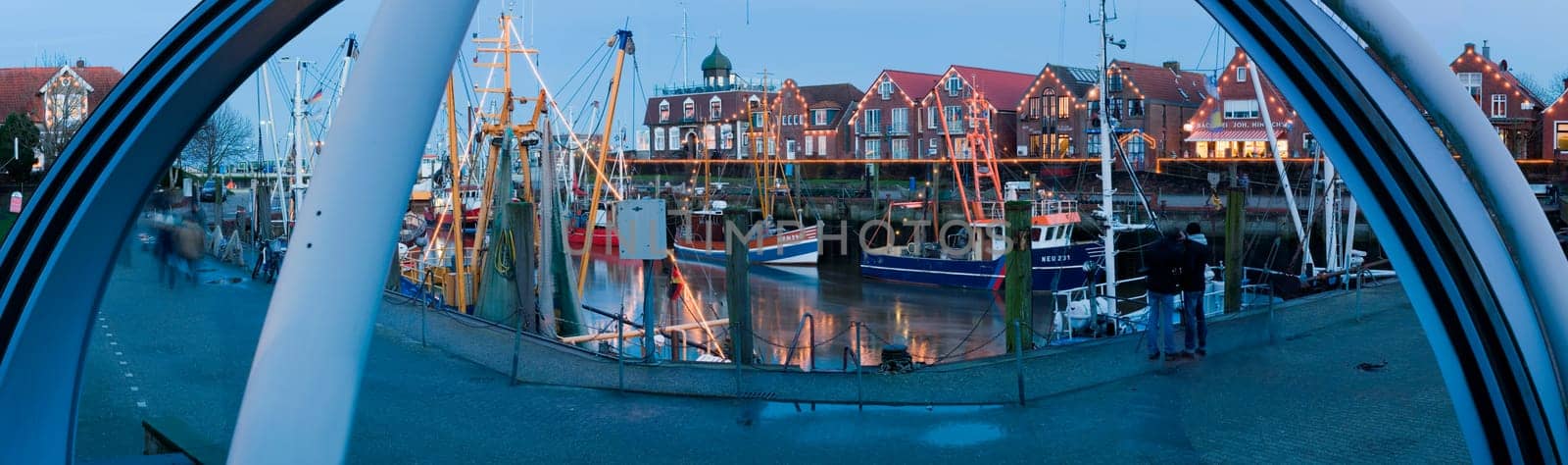 Neuharlingersiel,Germany - January 1,2014: Panoramic view of the port of Neuharlingersiel in the evening-dawn