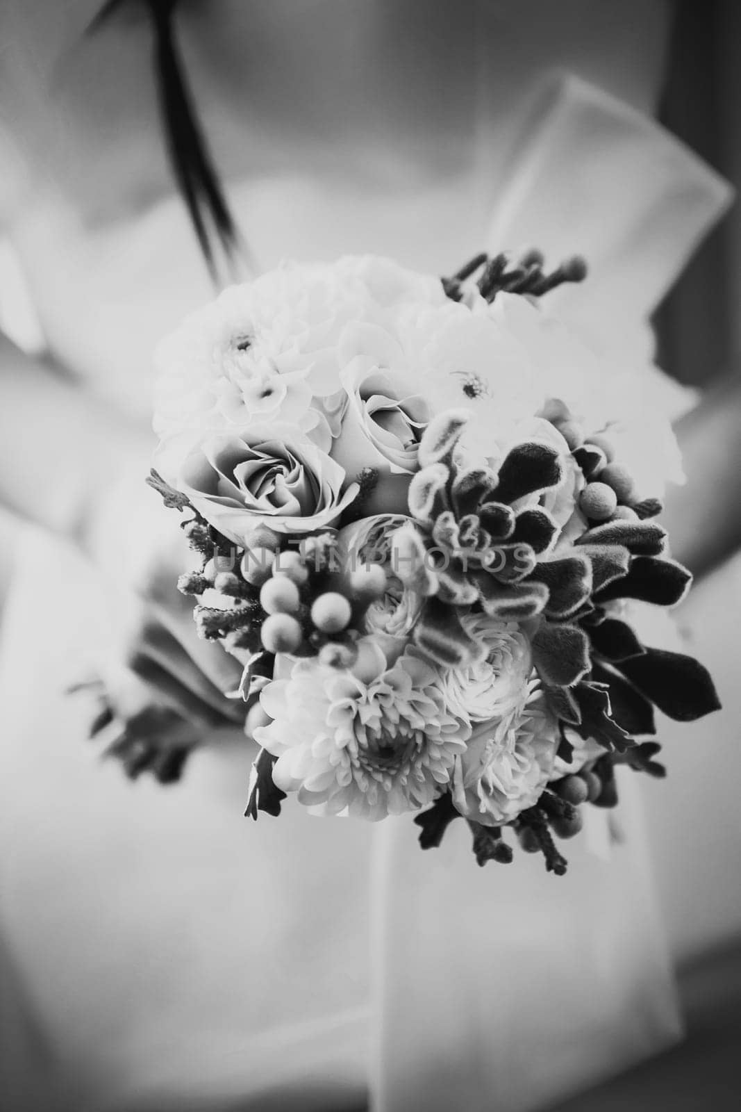Black white photography beautiful wedding bouquet of flowers in hands the bride