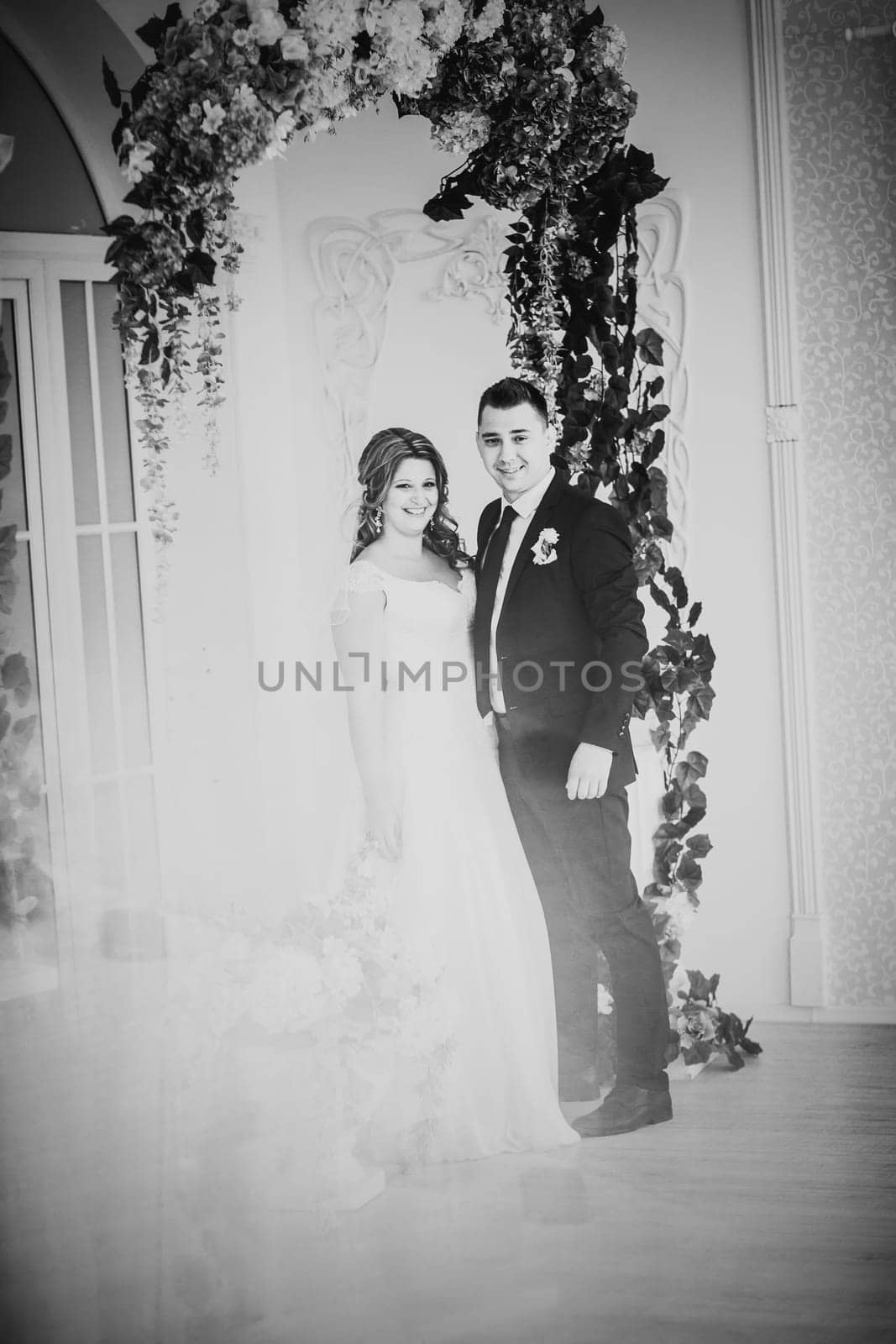 Black white photography bride and groom posing in a hotel room