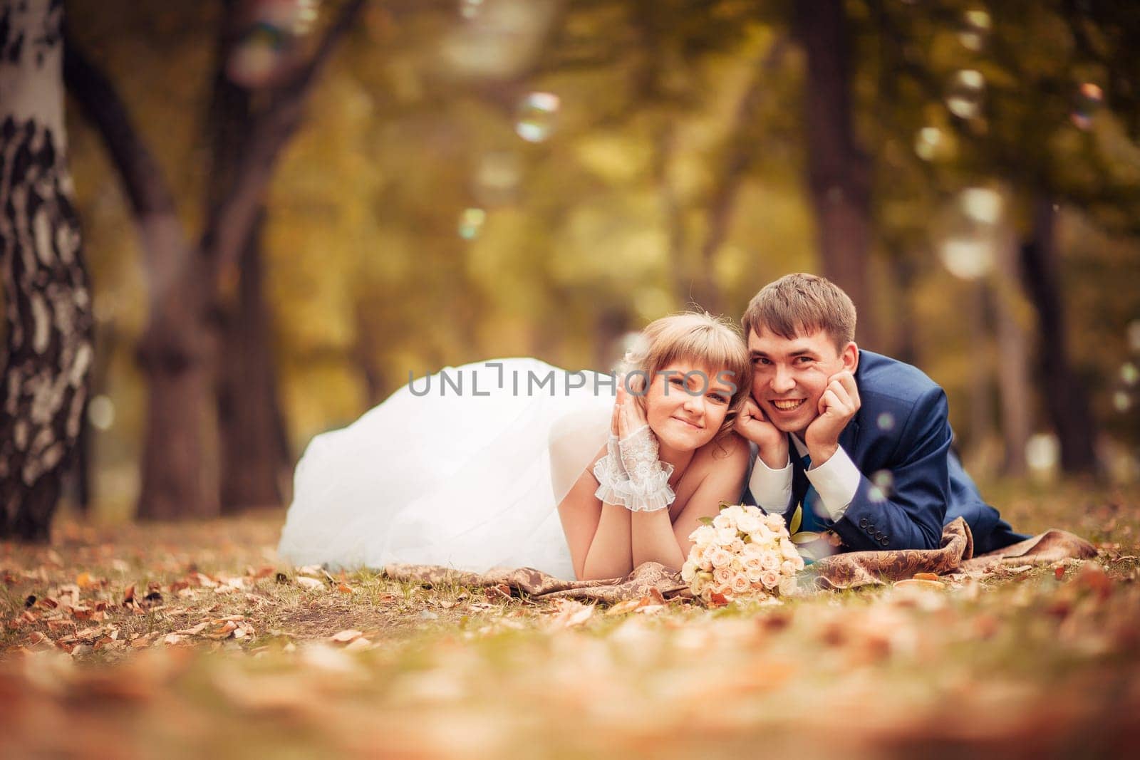 young bride and groom on the background of the autumn landscape