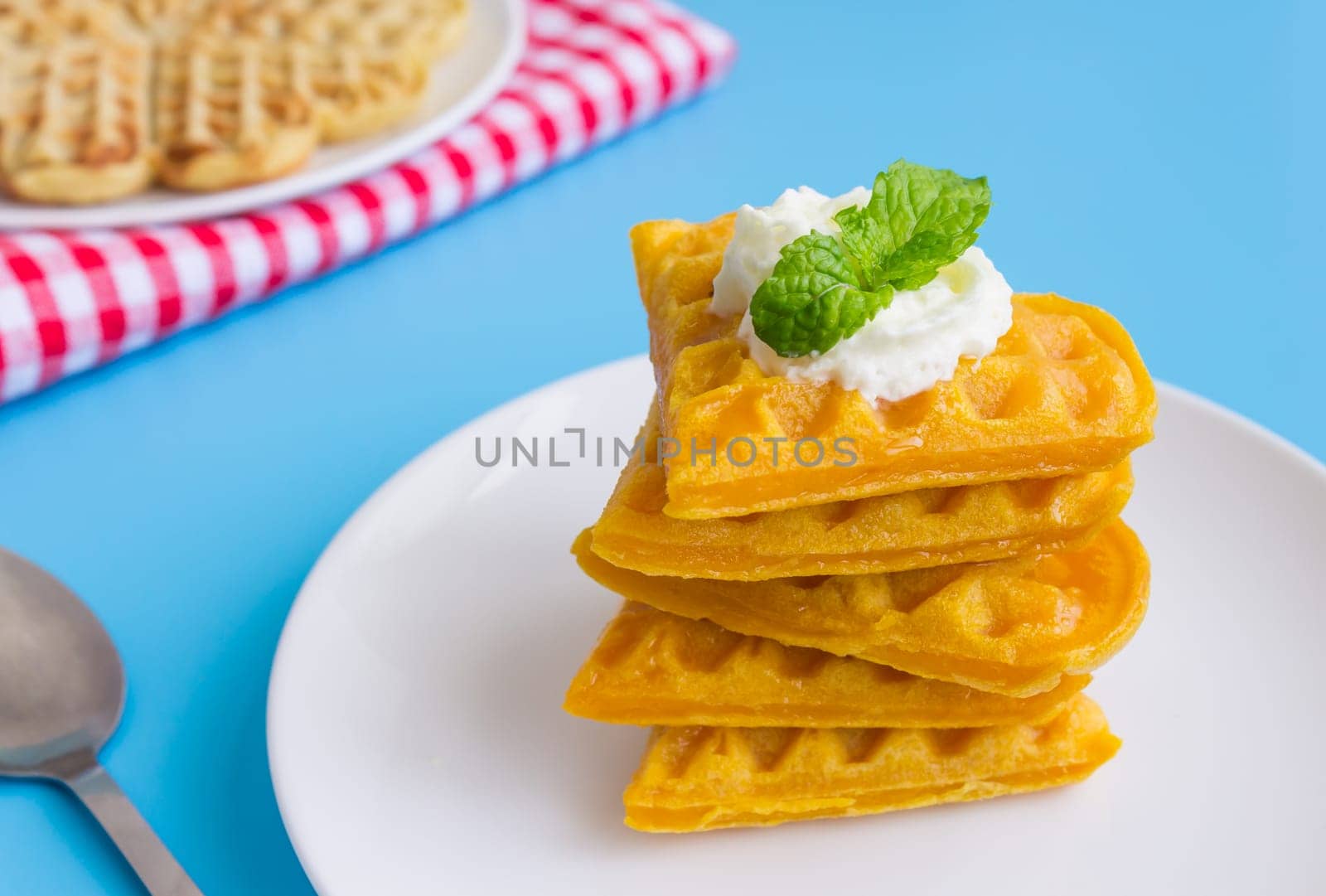 5 Pieces Heart Shape Waffle and Peppermint on Blue Pastel Background Right. Heart shape waffle dessert for food and dessert category