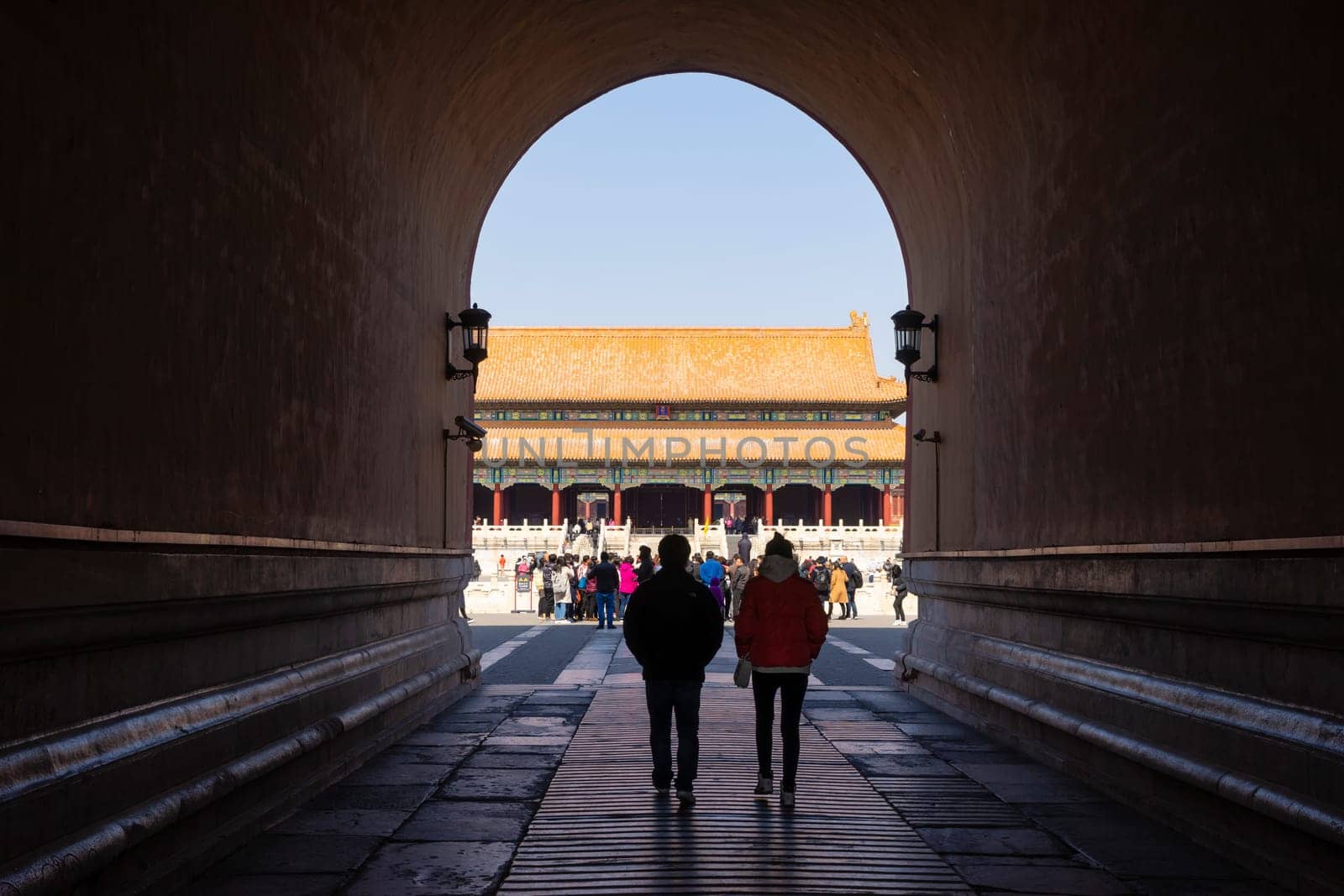 Beijing, China - Mar 16, 2018: View of people walking through the tunnel at the main gate of Forbidden City in Beijing. It is a palace complex in Beijing and a popular tourist attraction.