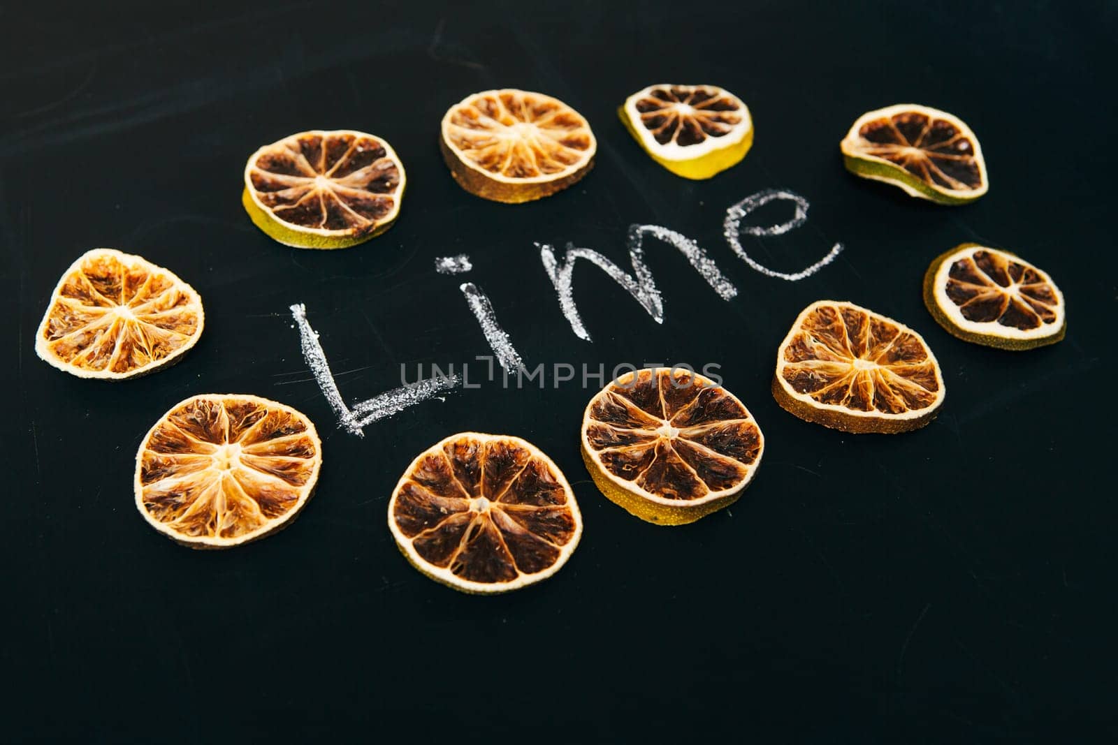 many cut orange circle on a black background board