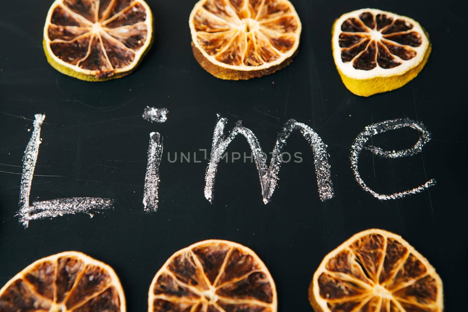 many cut orange circle on a black background board
