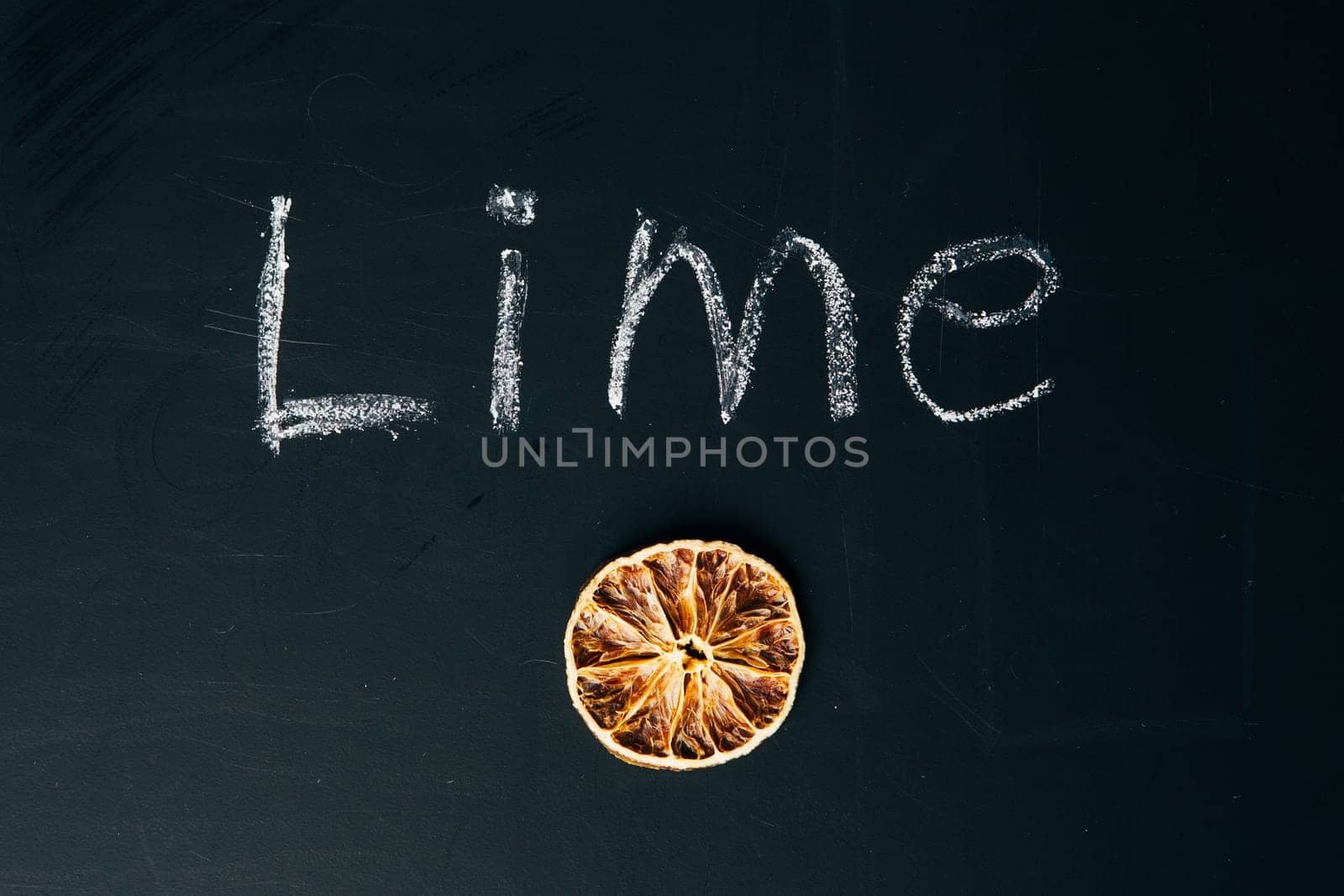 one sliced orange circle on a black background board