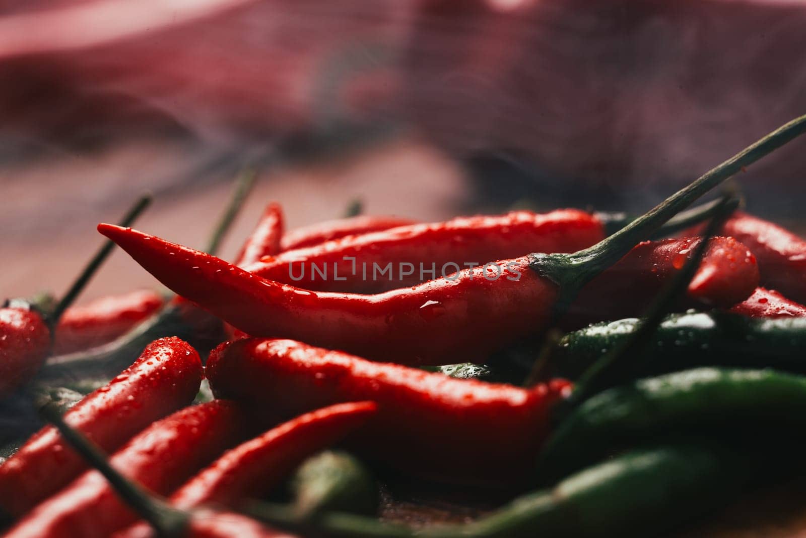red and green chili peppers close up on wooden background