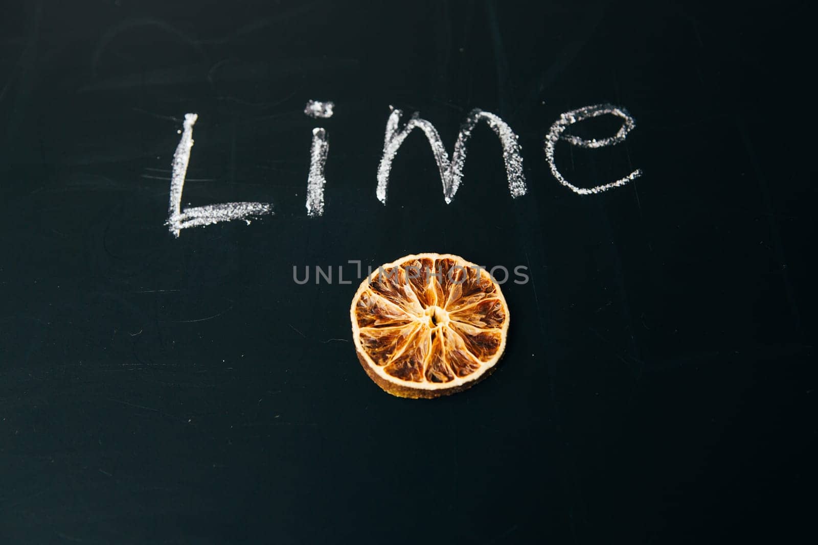 one sliced orange circle on a black background board