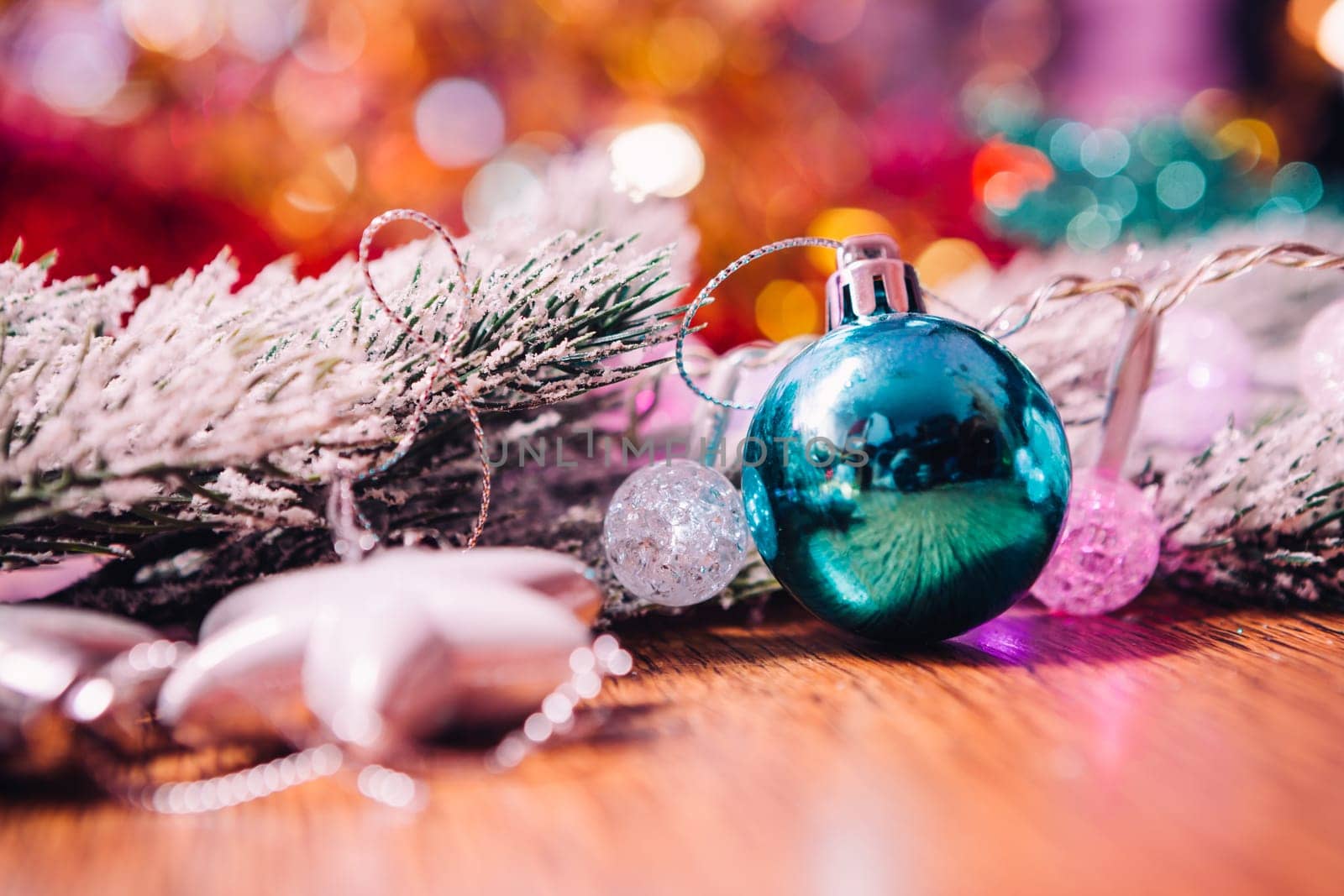 Spruce branches in the snow, and blue balls wooden background