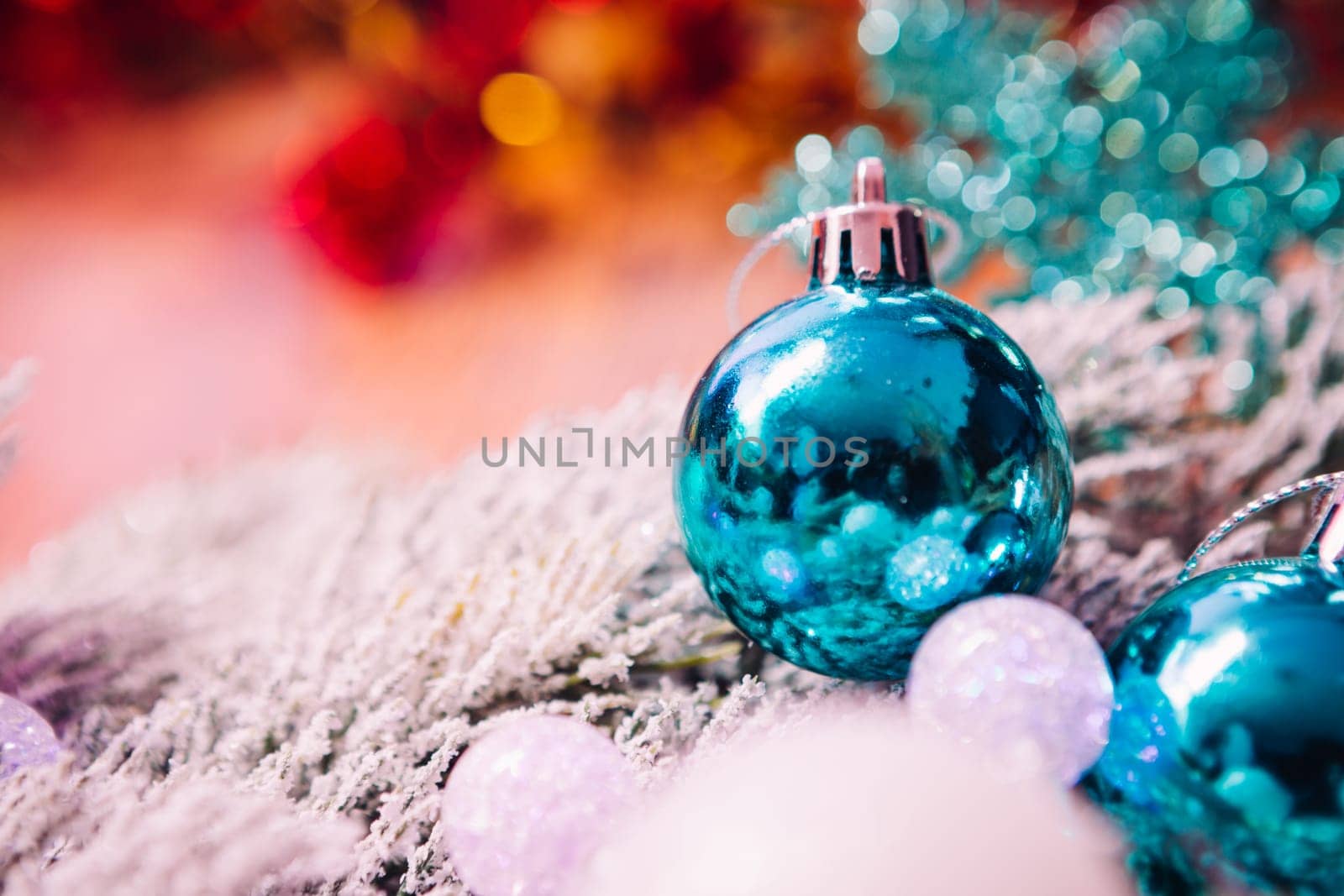 Spruce branches in the snow, and blue balls wooden background