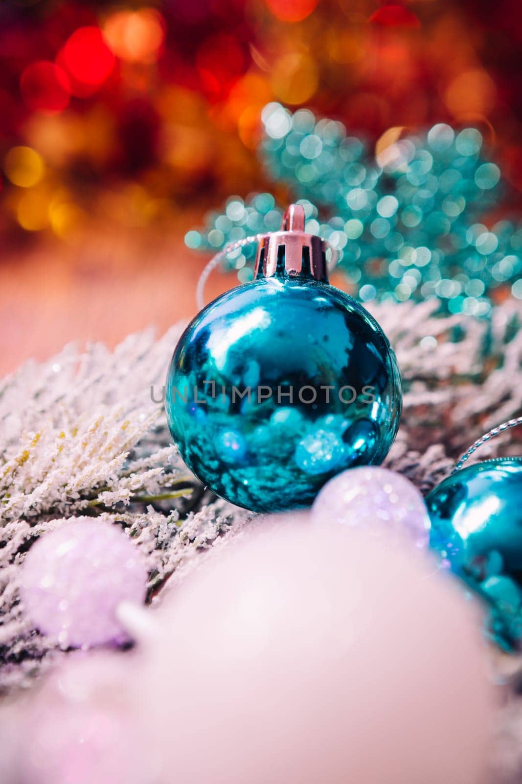 Spruce branches in the snow, and blue balls wooden background