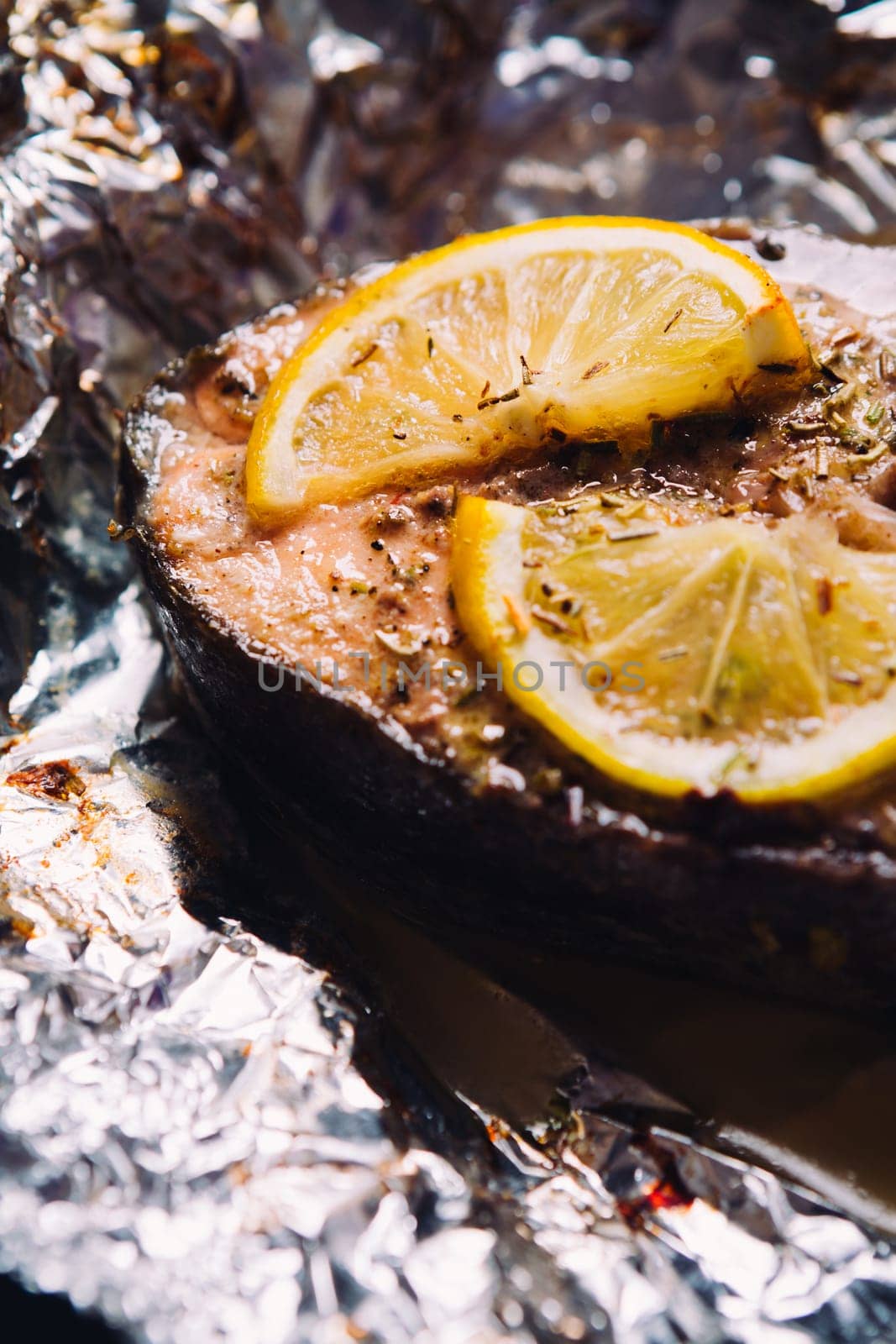 fish steak baked with lemon and herbs in foil