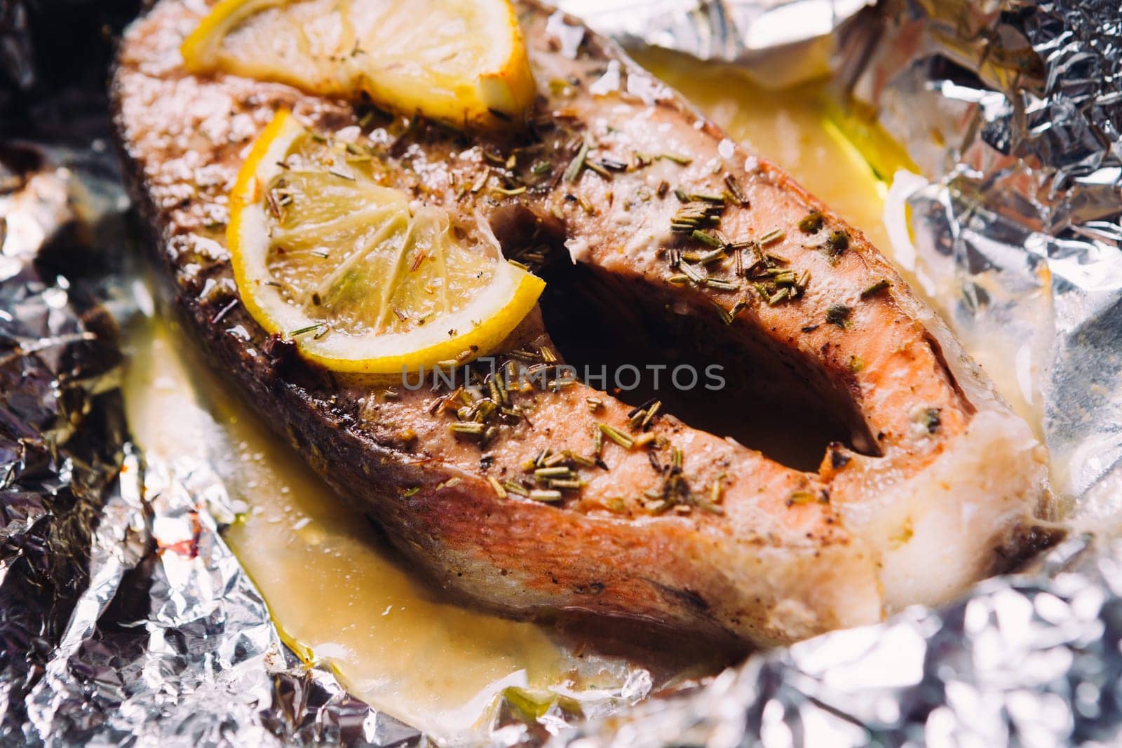 fish steak baked with lemon and herbs in foil