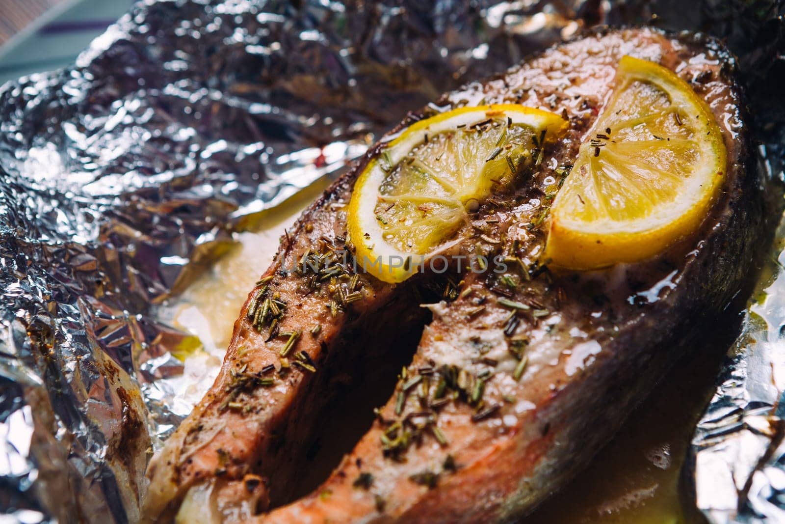 fish steak baked with lemon and herbs in foil