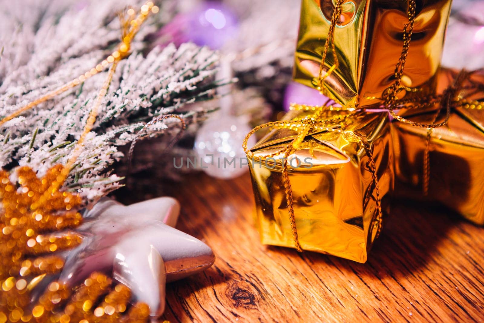 Spruce branches in the snow gold and white christmas decoration on wooden background