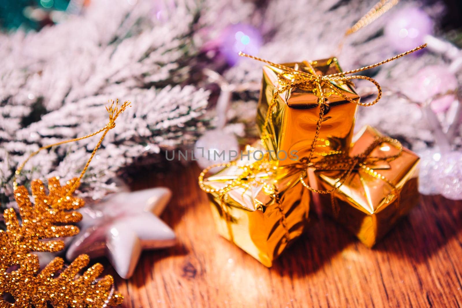 Spruce branches in the snow gold and white christmas decoration on wooden background