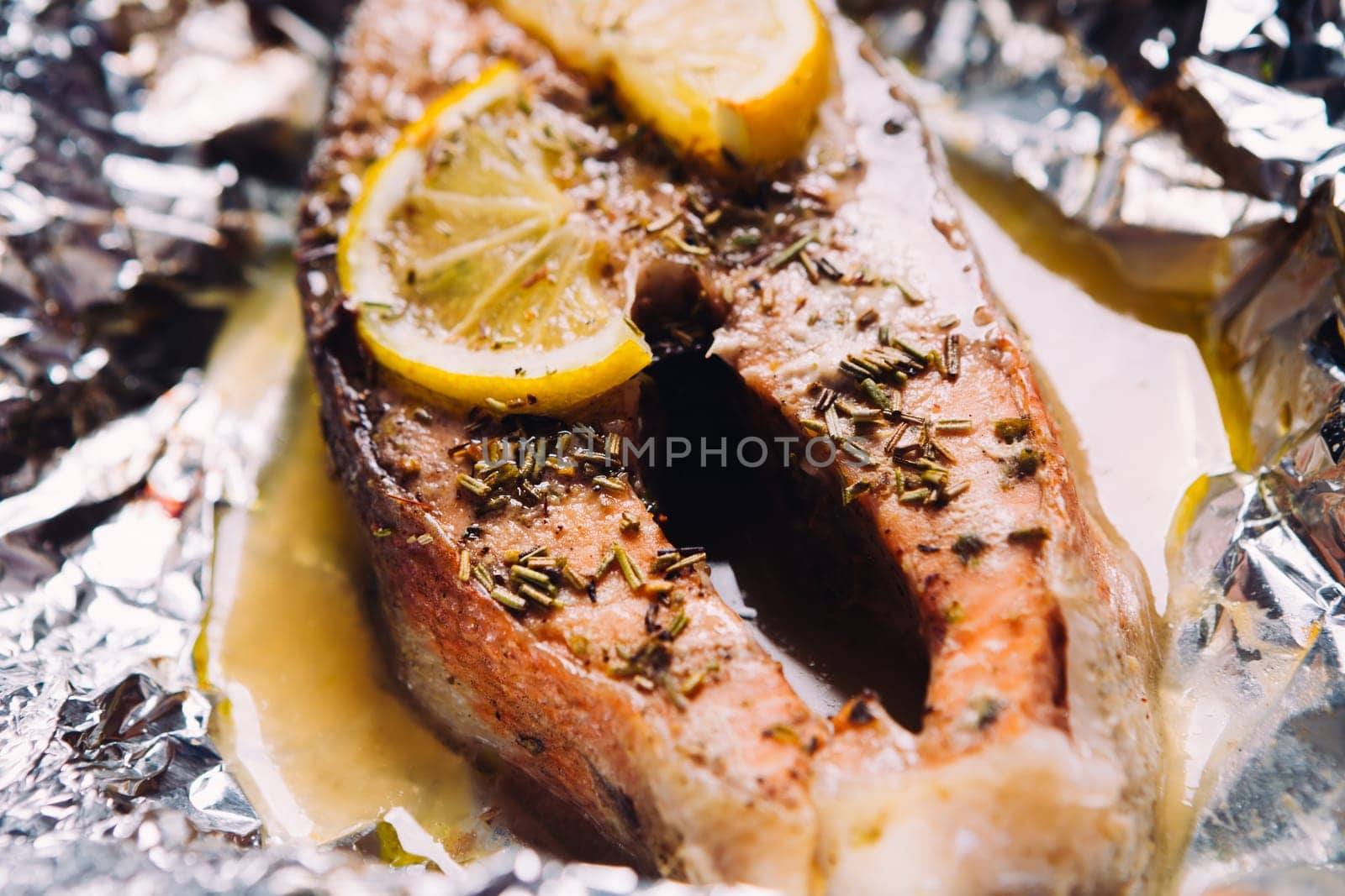 fish steak baked with lemon and herbs in foil