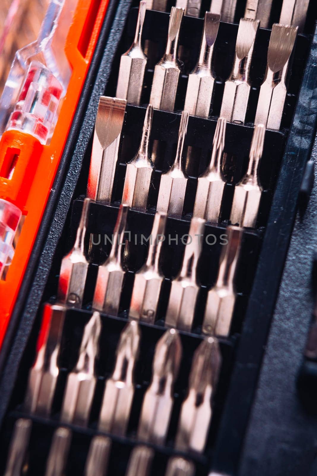 set of nozzles for screwdriver in red box on wooden background