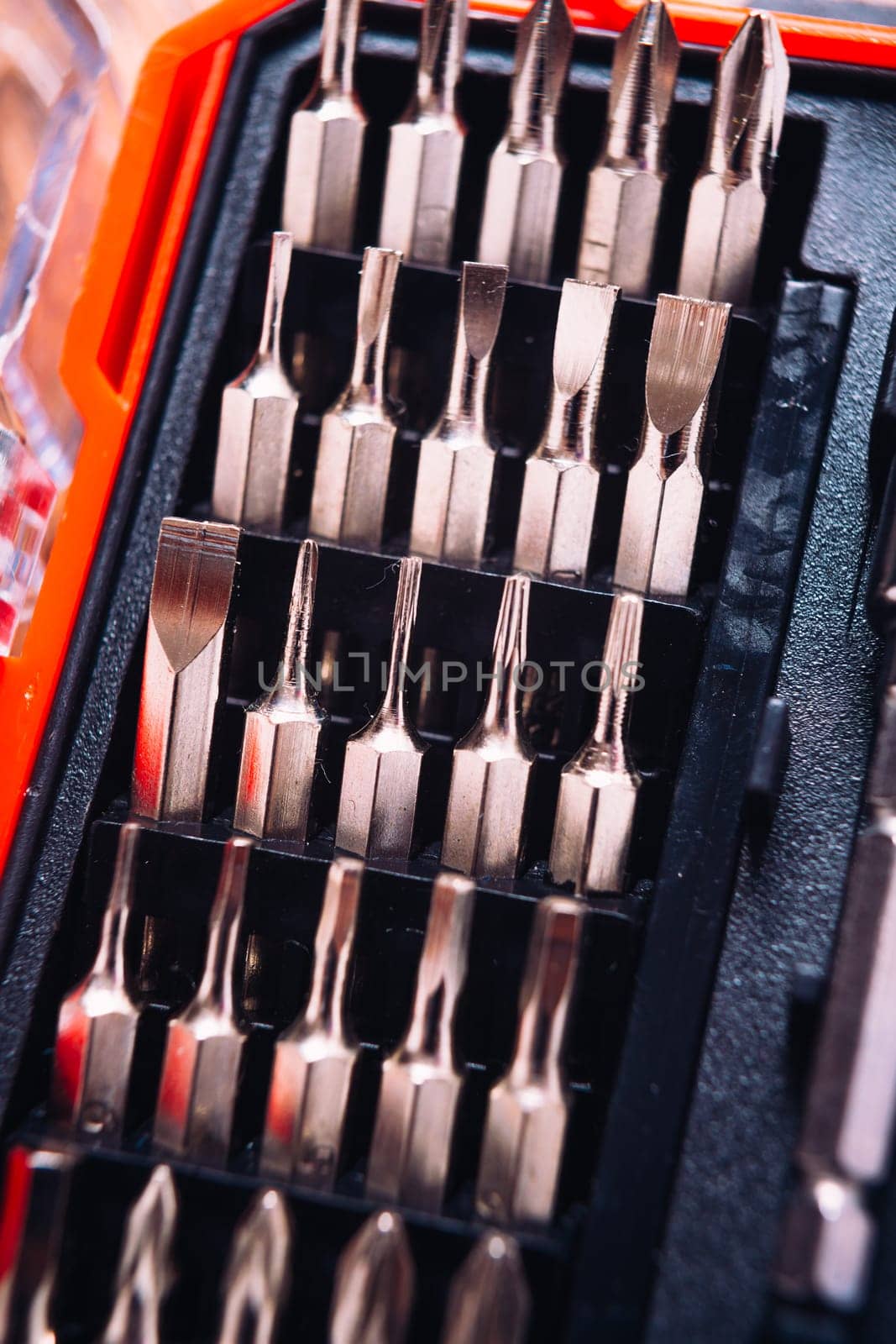 set of nozzles for screwdriver in red box on wooden background
