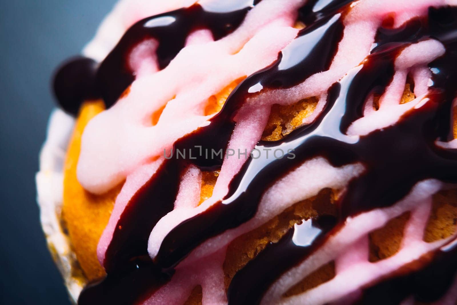 cupcake with pink frosting on a wooden background close up