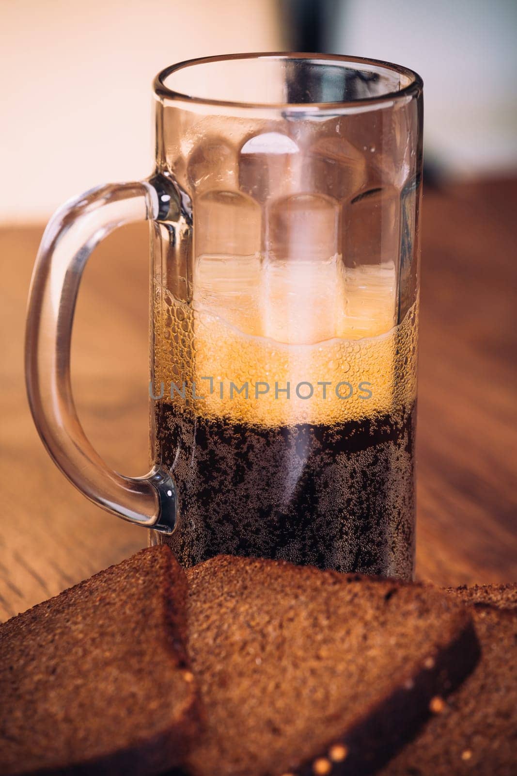 Russian brew in mug and loaf of rye flour on wooden background